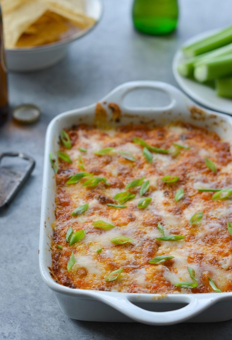 Buffalo chicken dip in a white baking dish.