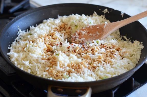 Skillet with riced cauliflower and soy sauce.