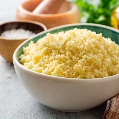steamed couscous in bowl with plaid linen napkin.