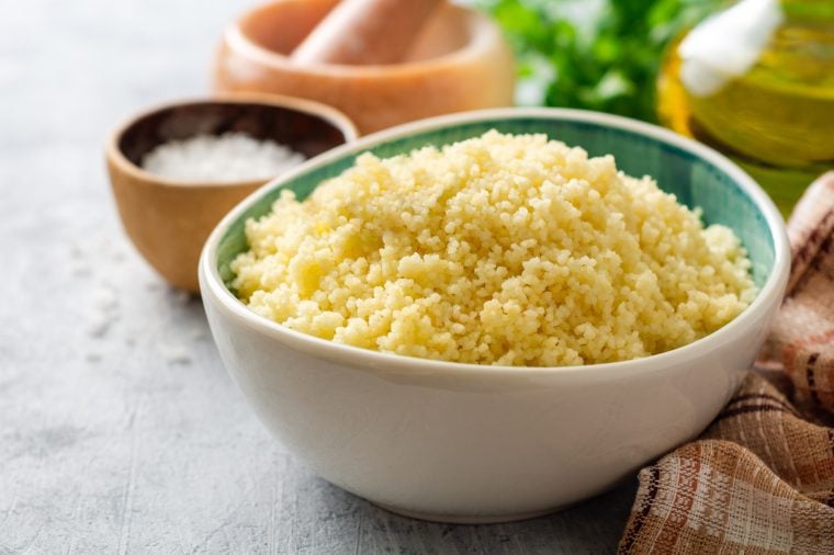 steamed couscous in bowl with plaid linen napkin.