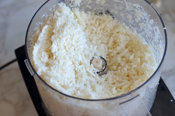 Food processor full of grated cauliflower rice.