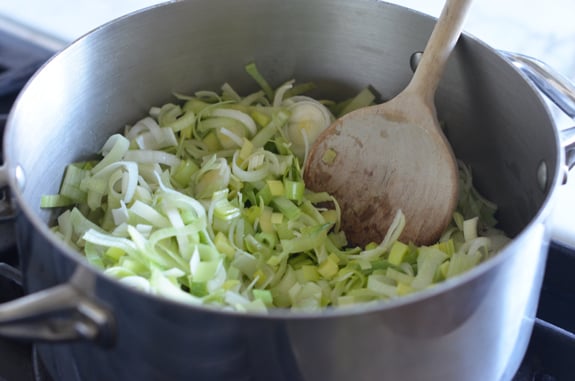 Leeks cooking in a pan.
