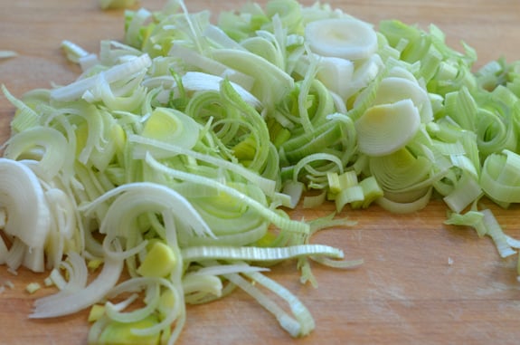 Sliced leeks on a cutting board.