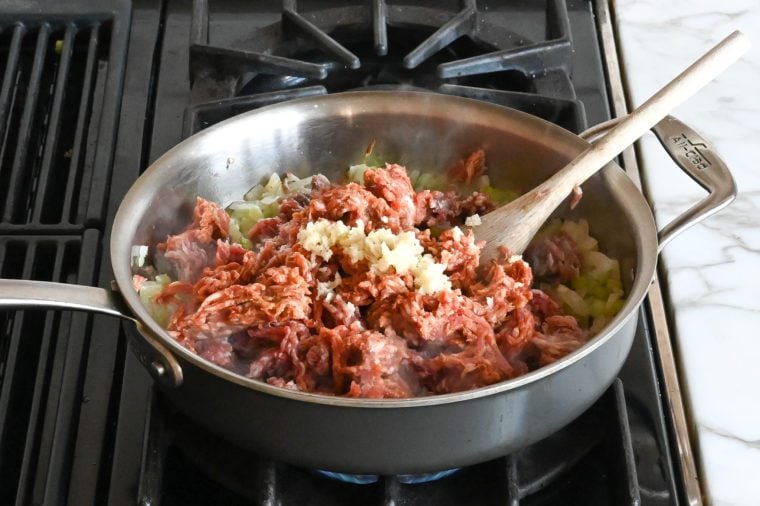 adding the garlic and sausage