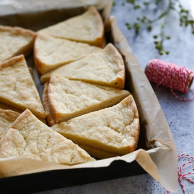 shortbread stacked in baking dish with Christmas ribbon.