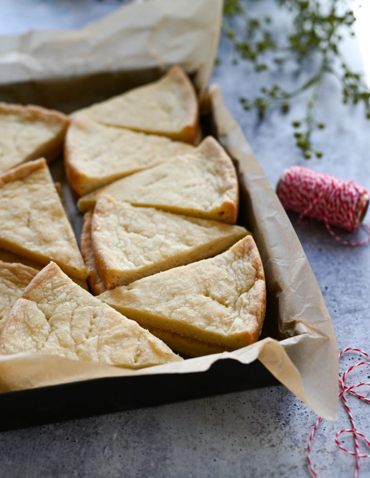 shortbread stacked in baking dish with Christmas ribbon.