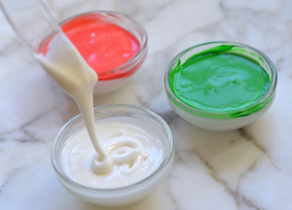White icing drizzling into a bowl.
