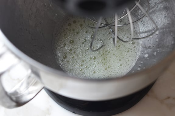 Foamy egg whites in a stand mixer.