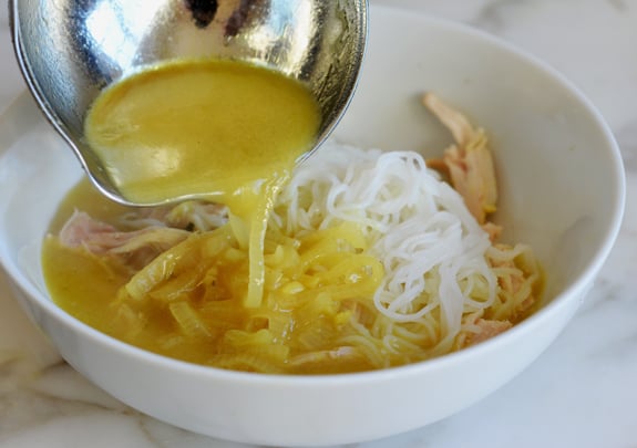 assembling bowl of thai chicken soup