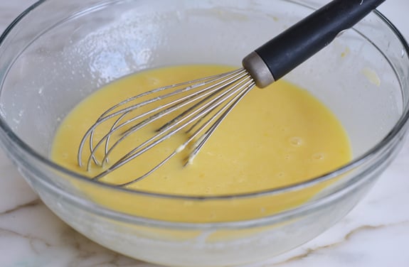 Whisk in a bowl of cake ingredients.