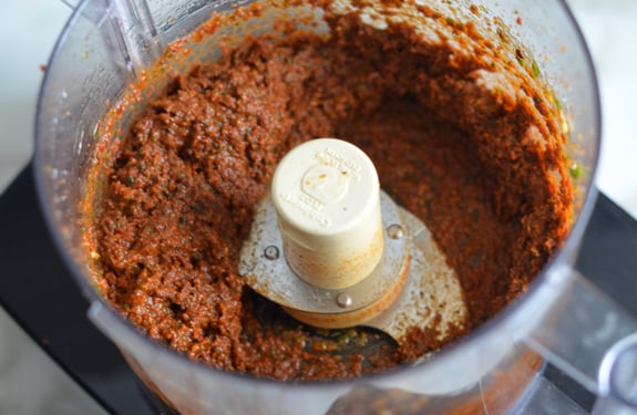 Food processor of sun-dried tomato pesto.