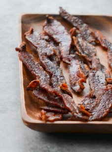 Wooden plate of candied bacon.