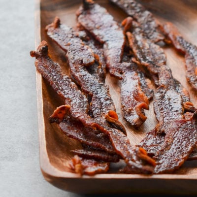 Wooden plate of candied bacon.