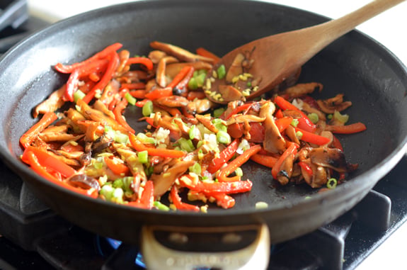 Skillet of vegetables cooking.