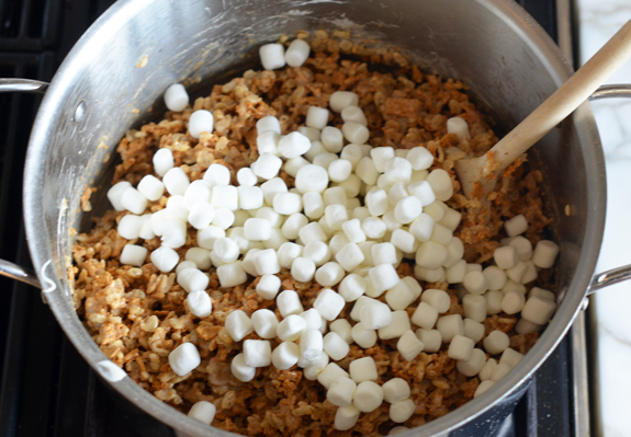 Marshmallows in a pot with a cereal mixture.