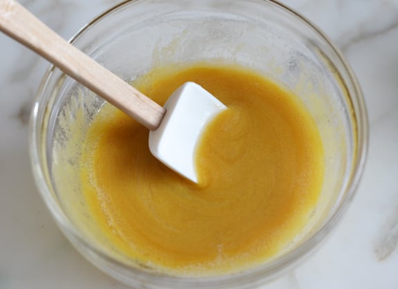 Spatula in a bowl of honey mustard.