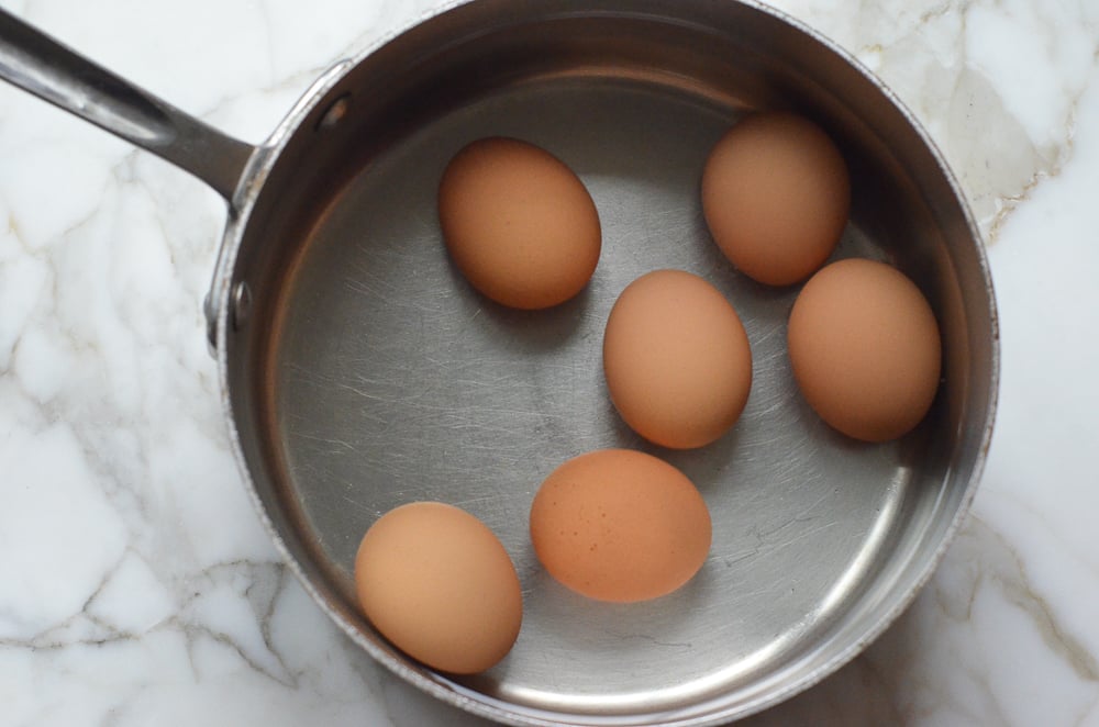 Boiled eggs in a pot covered with water. 