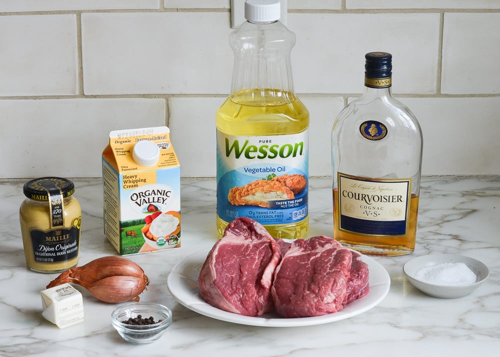 ingredients for making steak au poivre on a kitchen counter.