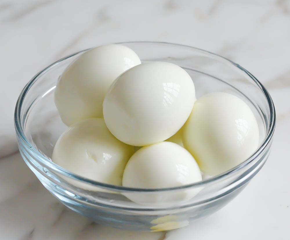 Bowl of peeled, hard-boiled eggs.