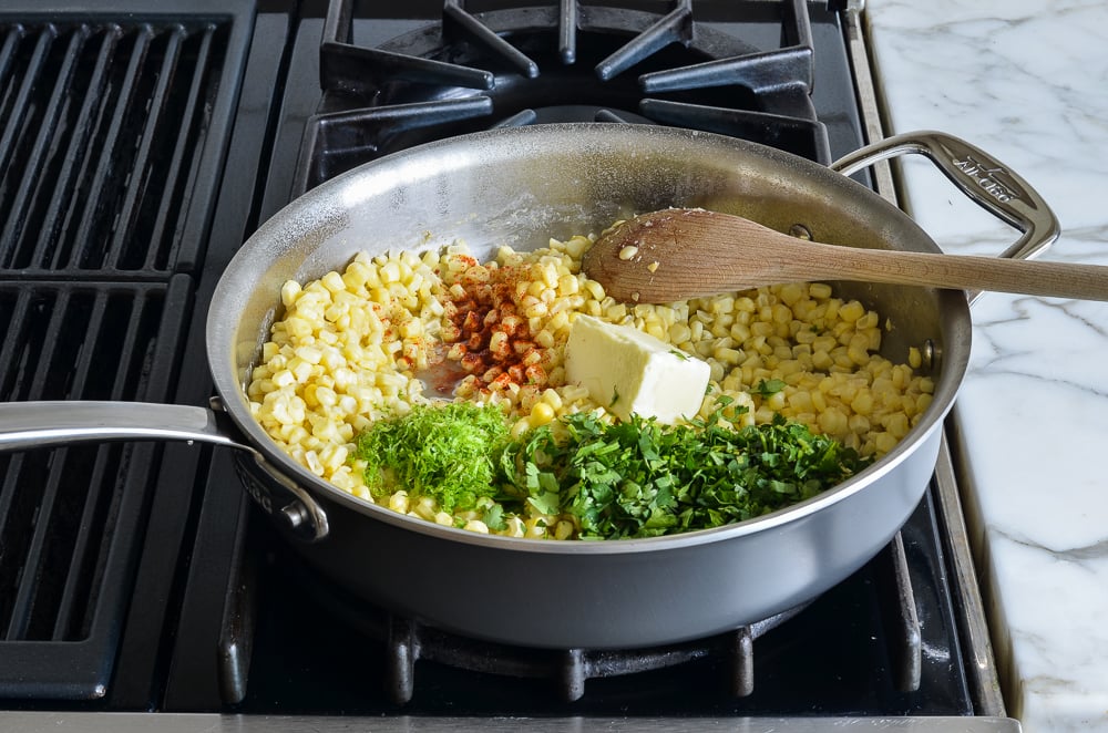 adding butter, spices, herbs, and lime to skillet