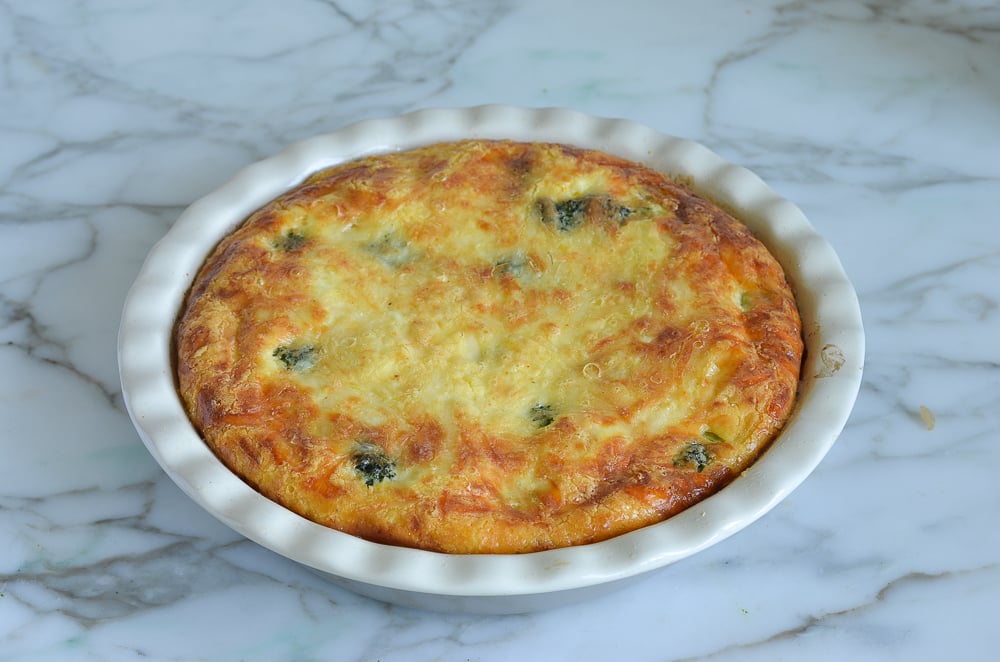 Crustless broccoli quiche in a pie pan.