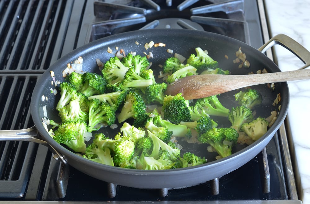Skillet of steamed broccoli.