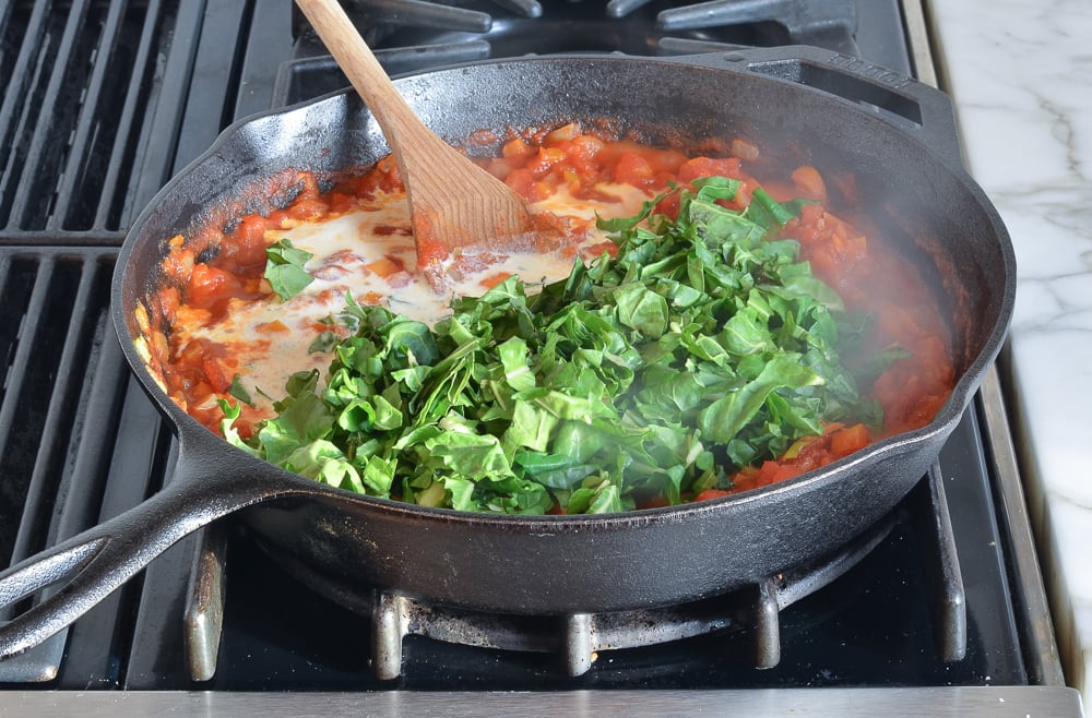 adding the cream and greens to the sauce