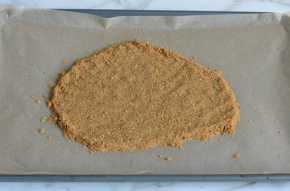 Crust pressed into a freeform layer on baking sheet.
