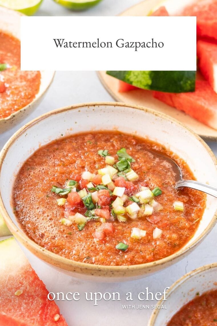 white bowl with watermelon gazpacho garnished with choppped celery, watermelon and basil