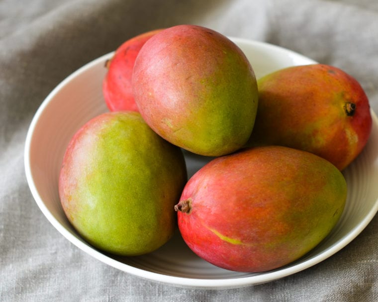 Bowl of whole mangos.