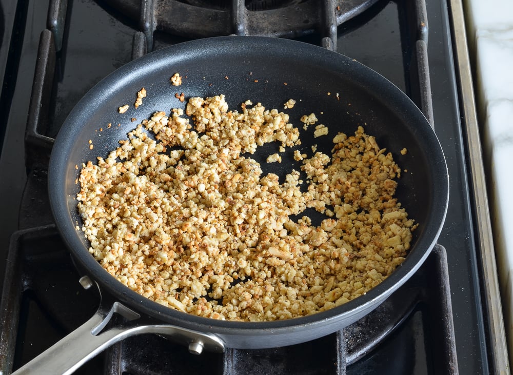 Processed nuts in a skillet.