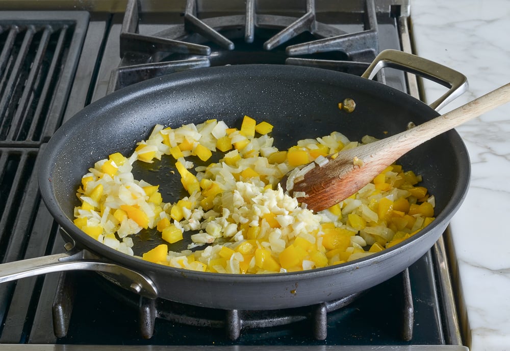 Onion and bell pepper in a skillet.