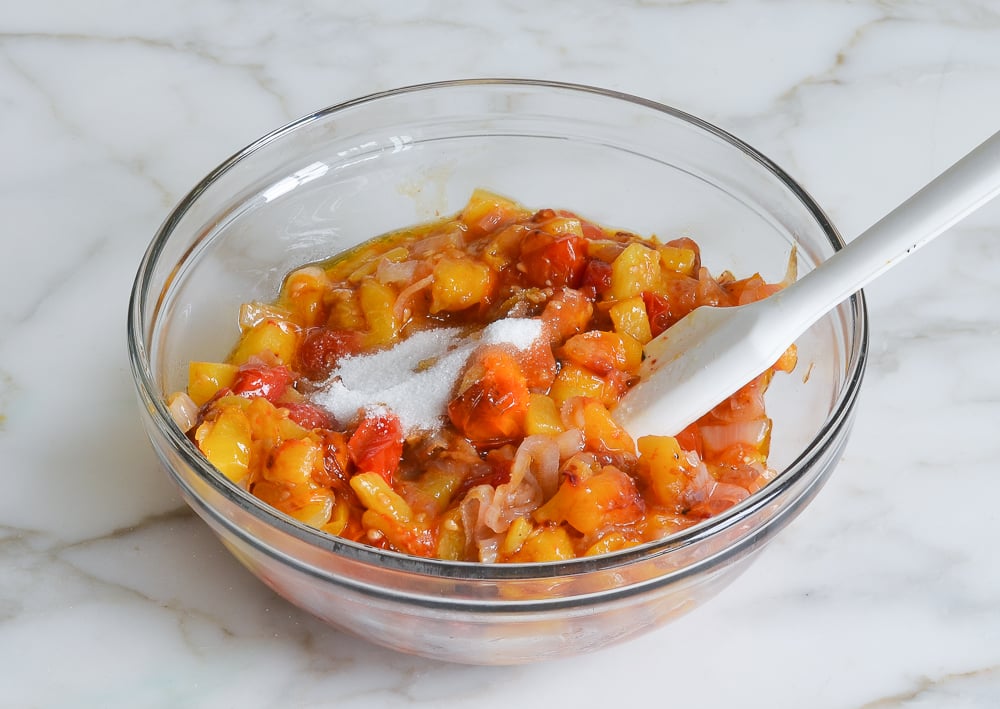 Sugar in a bowl with roasted vegetables.