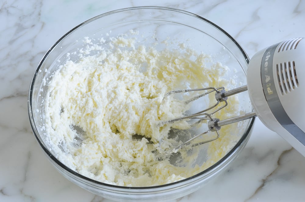 Beaten butter and sugar in a bowl.
