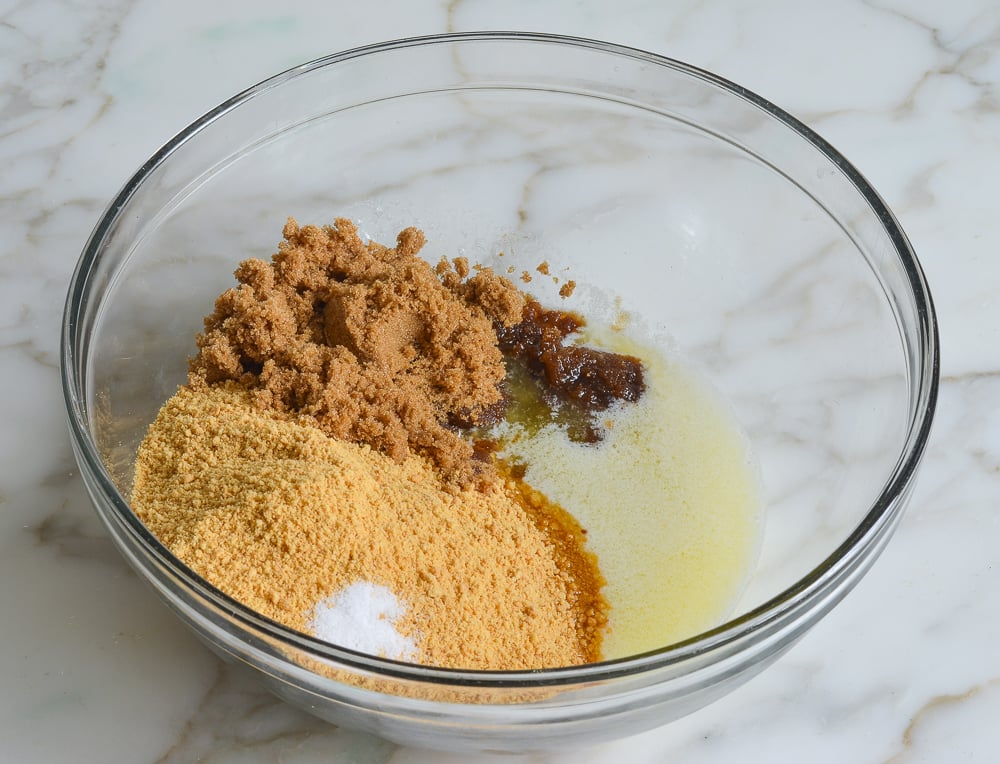 Bowl of unmixed graham cracker crust ingredients.