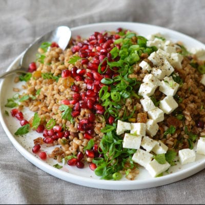 Plate of Egyptian barley salad with pomegranate vinaigrette.