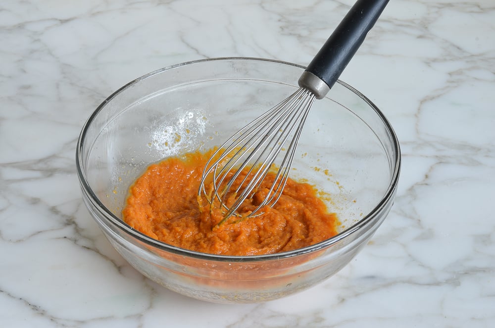 mixing pumpkin puree and butter for pumpkin pancakes