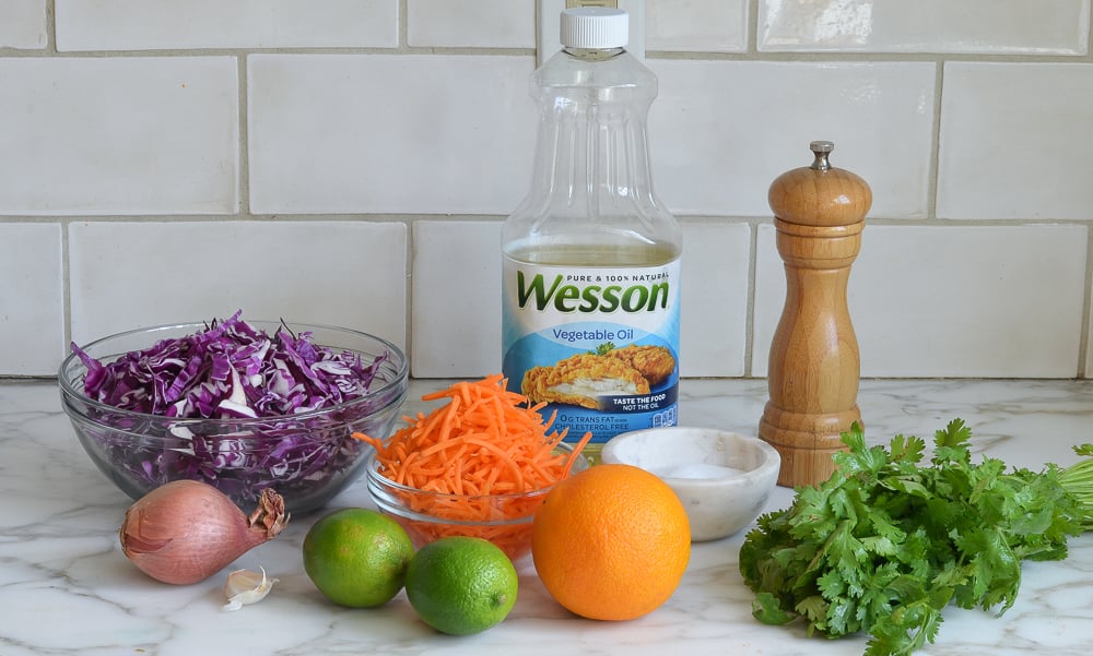 Slaw ingredients including carrots, lime, and garlic.