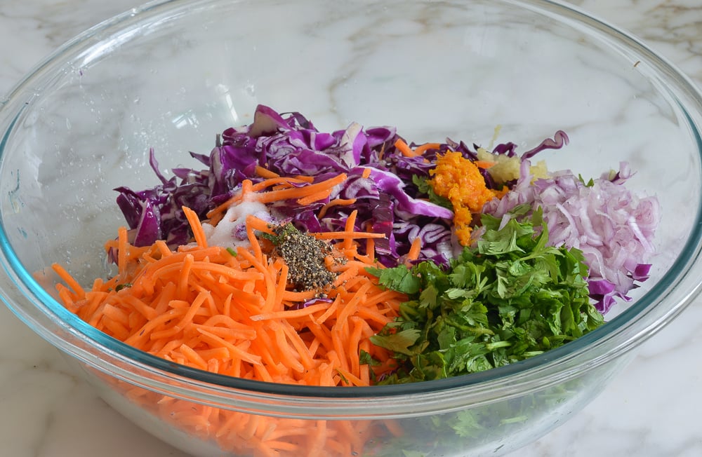 Bowl of unmixed slaw ingredients.