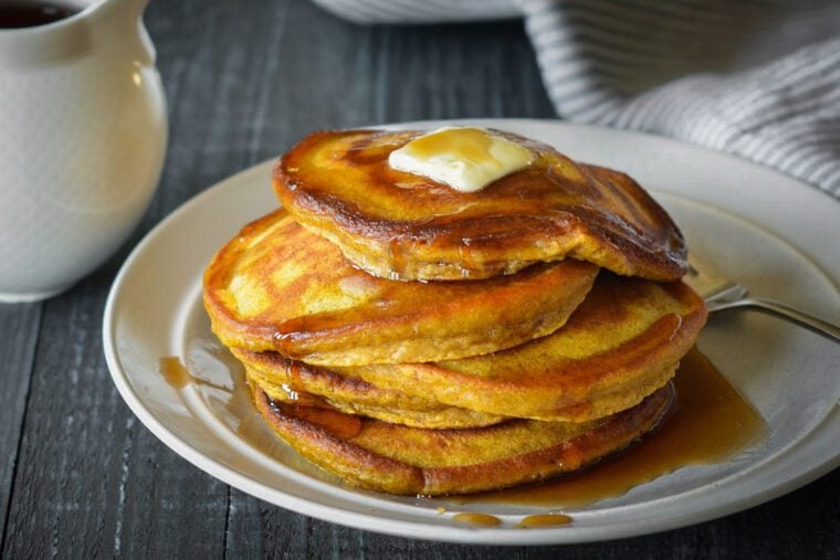pumpkin pancakes stacked on plate