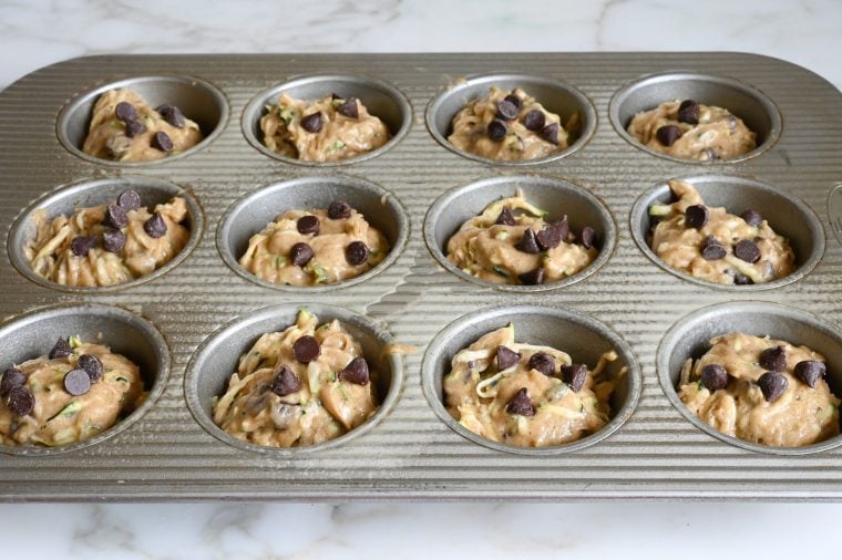 zucchini muffin batter in muffin pan
