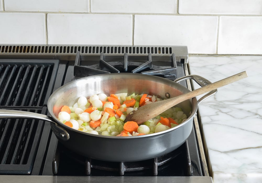 Vegetables cooking in a skillet.