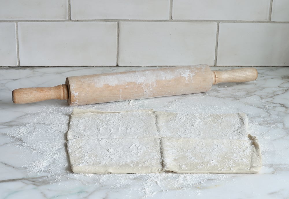 Puff pastry on a floured countertop.