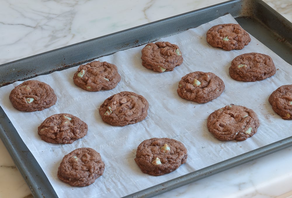 Double chocolate mine cookies on a lined baking sheet.