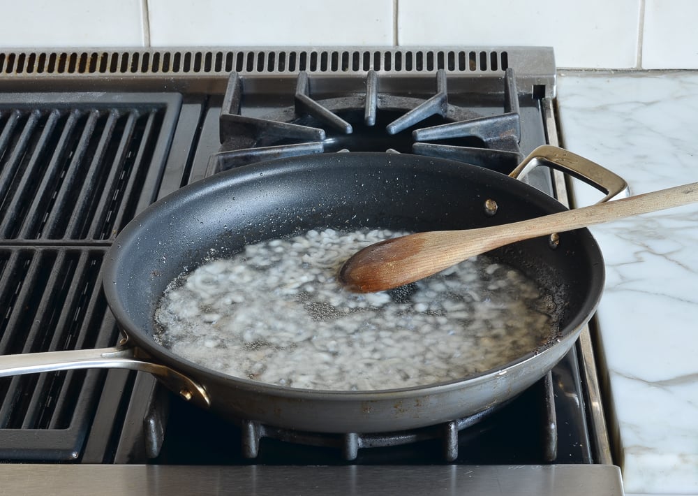 Shallots cooking in bacon fat.