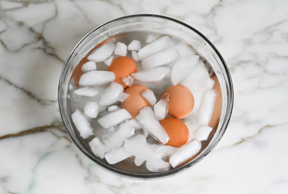 Hard boiled eggs cooling in ice bath