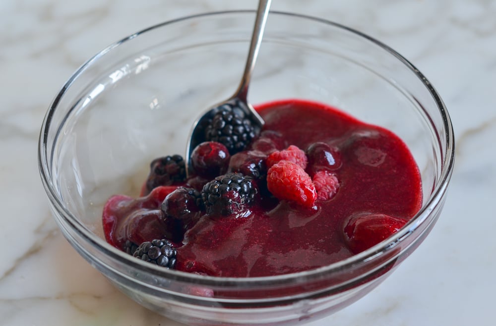 Berries in a bowl with berry sauce.