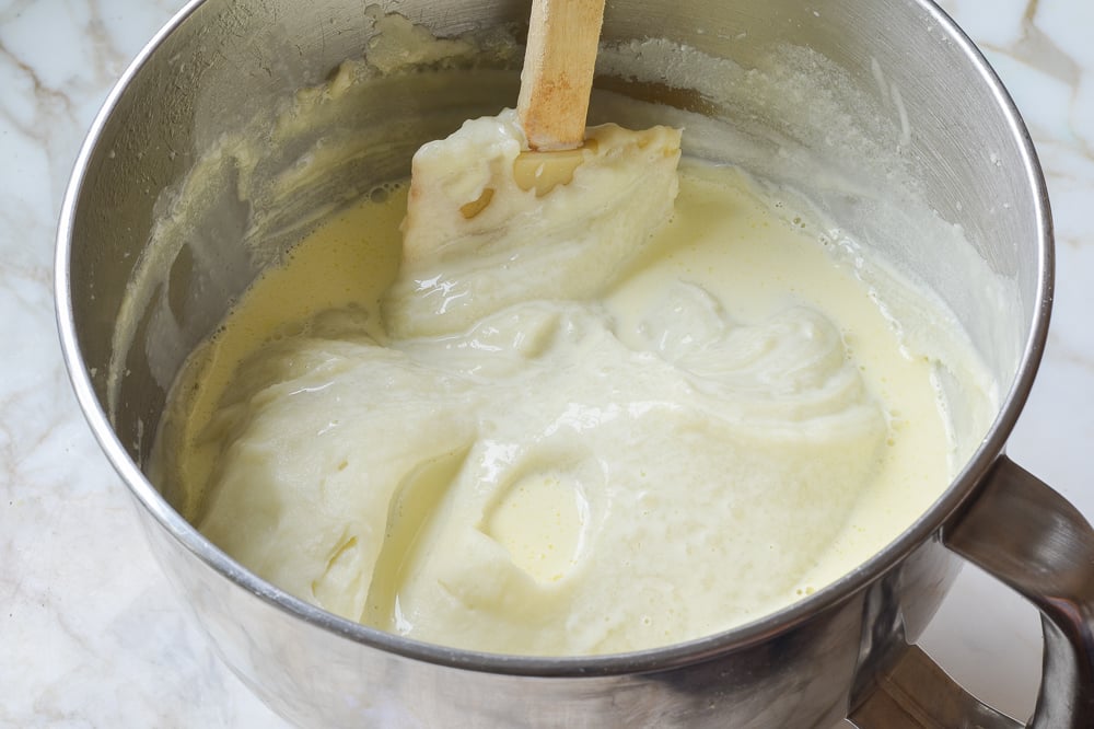 Spatula folding cream mixture into potatoes.