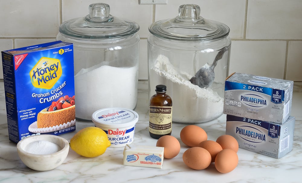 Cheesecake ingredients including eggs, sour cream, and lemon.