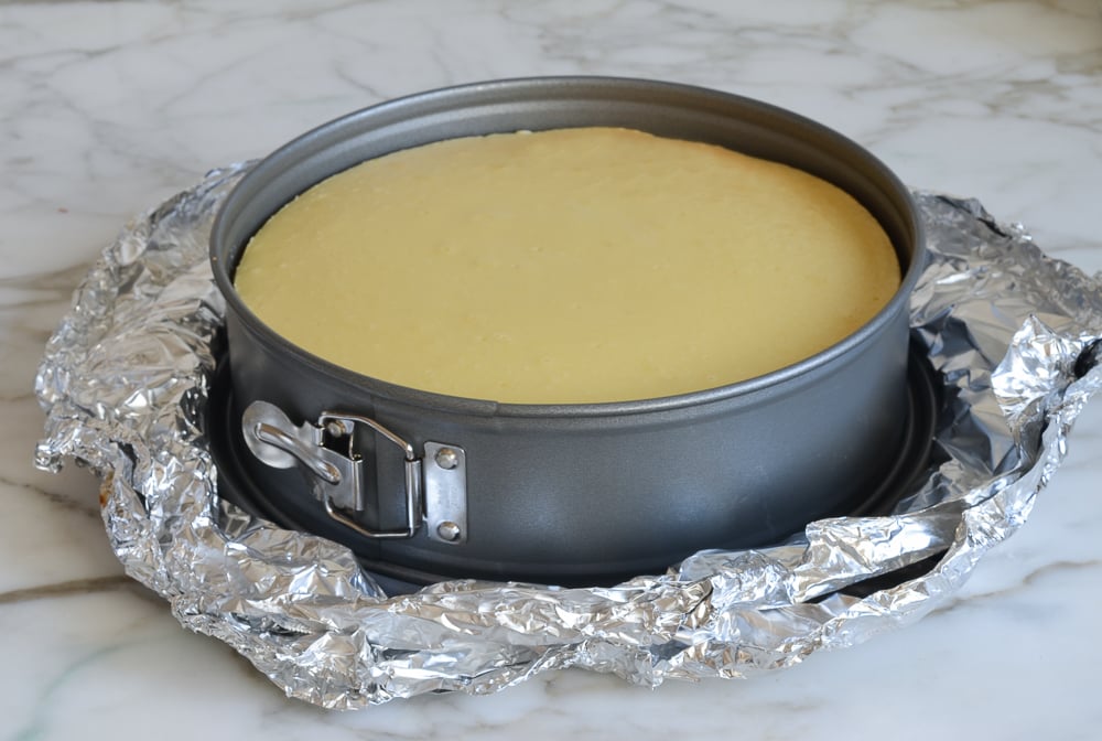 Cooked cheesecake in a springform pan.